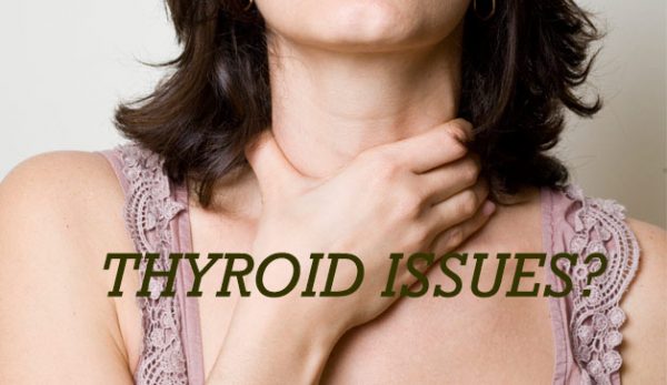 Woman holding neck suffering from thyroid issues